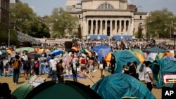 FILE - Student protesters gather inside their encampment on the Columbia University campus, on April 29, 2024, in New York.