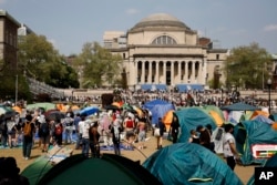 FILE - Student protesters gather inside their encampment on the Columbia University campus, on April 29, 2024, in New York.