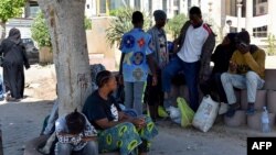FILE: Migrants gather at a pubic space in Sfax on July 5, 2023. Racial tensions in the Tunisian coastal city of Sfax flared into violence targeting migrants from sub-Saharan Africa, dozens of whom were forcibly evicted from the city, witnesses said.