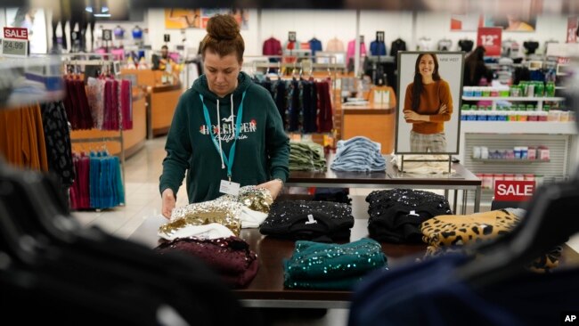 An employee straightens displays at a Kohl's store in Clifton, N.J., Jan. 26, 2024.