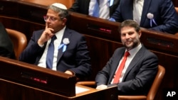 FILE - Israeli right wing Knesset member Itamar Ben Gvir, left, and Bezalel Smotrich look on during the swearing-in ceremony for Israeli lawmakers at the Knesset, Israel's parliament, in Jerusalem, Nov. 15, 2022.