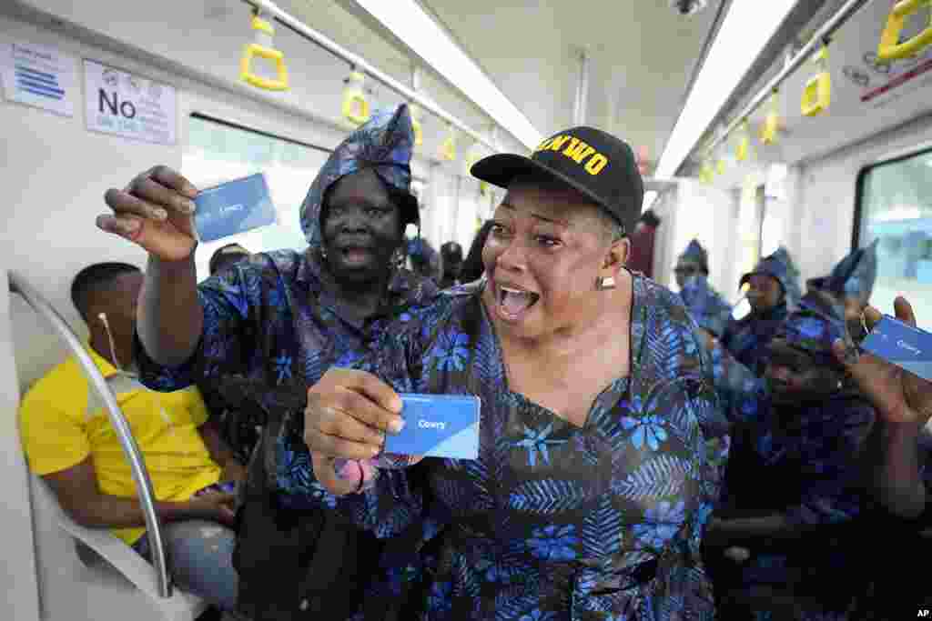 People sing as the ride on a new Lagos blue line train service in Lagos, Nigeria, Monday, September 4, 2023. Lagos state government on Monday, began its 13km (9 miles) metro blue line services to the public.&nbsp;