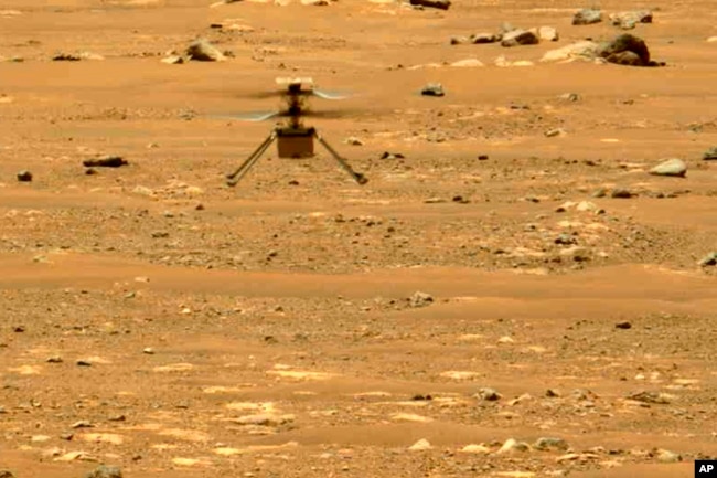 In this file image made available by NASA, the Mars Ingenuity helicopter hovers above the surface of the planet during its second flight on April 22, 2021. (NASA/JPL-Caltech/ASU/MSSS via AP, File)
