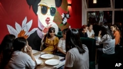 FILE - Girls eat in a restaurant in Aralsk, Kazakhstan, July 4, 2023.