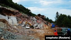 Rescuers work at the site after a landslide overtook the highway construction site on an expressway in Wufeng county, Hubei province, China, July 9, 2023. 
