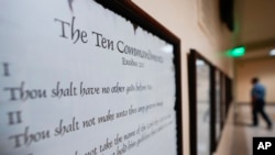 FILE - A copy of the Ten Commandments is posted along with other historical documents in a hallway of the state capitol in Atlanta, Georgia, June 20, 2024.