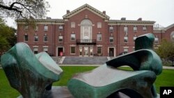 FILE - The sculpture Reclining Figure No. 2 — Bridge Prop (1963), by Henry Moore, rests in a quad on the campus of Brown University, in Providence, R.I., Oct. 12, 2020. 