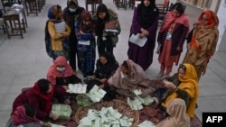 Election officials count votes after polls end during country's national elections in Islamabad on Feb. 8, 2024. 