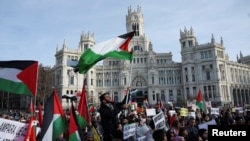 FILE - People attend a protest calling for a cease-fire in Gaza, amid the ongoing conflict between Israel and the Palestinian Islamist group Hamas, outside Cibeles Palace in Madrid, Jan. 27, 2024.