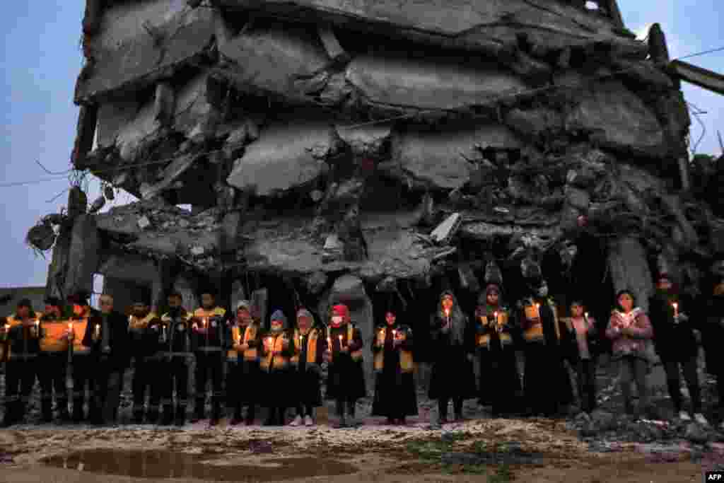 Members of the Syrian Civil Defense along with survivors of last year&#39;s catastrophic earthquake mark the one-year anniversary of the earthquake that destroyed northern Syria and Turkey, in Jindayris in the northwest of Syria&#39;s Aleppo province, Syria.