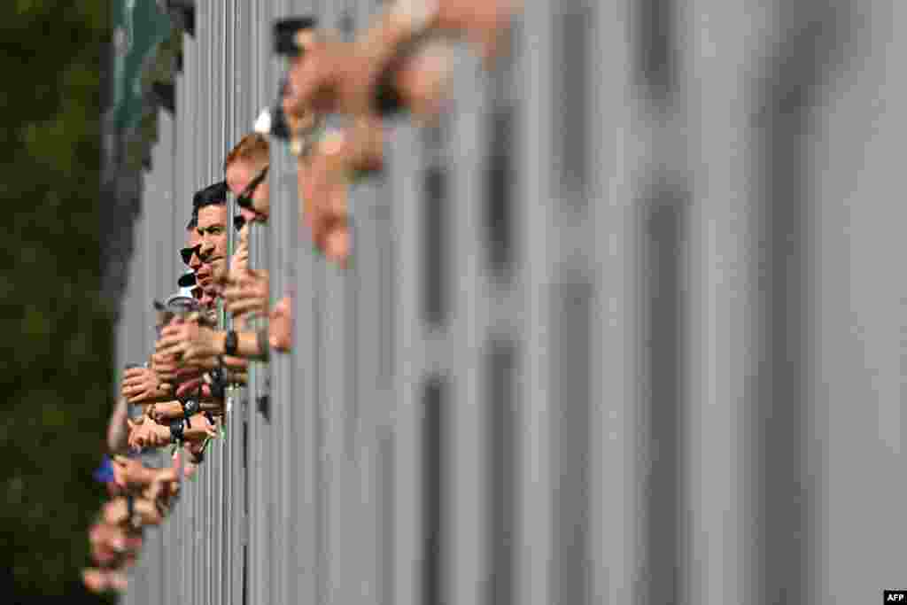 Spectators watch from the hospitality enclose overlooking the 18th hole on day two of the BMW PGA Championship at Wentworth Golf Club, south-west of London. (Photo by Glyn KIRK / AFP)