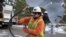 A worker from Portland General Electric replaces a power line as crews work to restore power after a storm on Jan. 16, 2024, in Lake Oswego, Oregon, Feb. 2, 2024, the U.S. government issues its January jobs report. 
