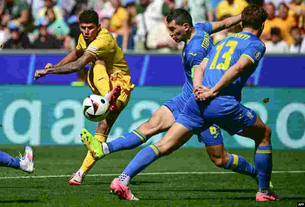 Romania&#39;s forward #17 Florinel Coman shoots on target during the UEFA Euro 2024 Group E football match between Romania and Ukraine at the Munich Football Arena in Munich, Germany.