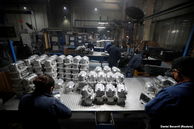 People work at the Pace Industries aluminum injection molding plant, company that recruits migrant asylum seekers through a UNHCR refugee program, in Saltillo, Mexico October 16, 2023. (REUTERS/Daniel Becerril)