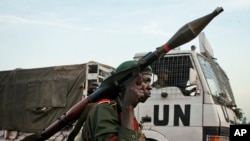 FILE - A Congolese government soldier (FARDC) stands guard by a UN truck at the Kibati checkpoint north of Goma, eastern Congo, on Nov. 23, 2008.