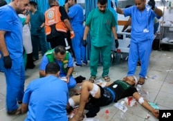 A wounded Palestinian man receives treatment at Kama Adwan hospital following Israeli bombardment on a UN school used as shelter, in Jabaliya, on the outskirts of Gaza City, Nov. 2, 2023.