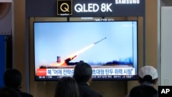 A TV screen shows an image of North Korea's missile launch during a news program at the Seoul Railway Station in Seoul, South Korea, April 20, 2024. 