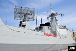 Chinese and Nigerian flags fly on a Chinese Navy Task Group 162 warship on a visit to Nigeria at Apapa harbor in Lagos, on July 4, 2023.