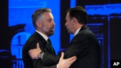 FILE - Socialist Party leader Pedro Nuno Santos, left, and Luis Montenegro, leader of the Social Democratic Party, greet each other before an election TV debate in Lisbon, Feb. 19, 2024. 
