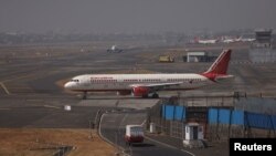 FILE - An Air India passenger aircraft is seen on the tarmac at Chhatrapati Shivaji International airport in Mumbai, India, Feb. 14, 2023