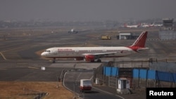 FILE - An Air India passenger aircraft is seen on the tarmac at Chhatrapati Shivaji International airport in Mumbai, India, Feb. 14, 2023