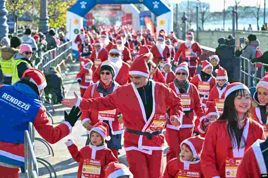 People in Santa Claus costumes take part in the traditional Christmas Santa Claus run on the banks of the River Danube in Budapest, Hungary.