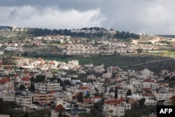 The village of Turmus Ayya near the city of Ramallah shows in the background the nearby Israeli Shilo settlement, in the occupied West Bank on February 18, 2024. (Photo: AFP)