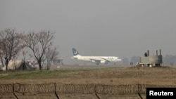 FILE - A Pakistan International Airlines passenger plane prepares to take off from the Benazir International airport in Islamabad, Feb. 9, 2016. The International Air Transport Association warned that foreign airlines could stop operating in Pakistan because of payment issues.
