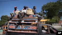 FILE - Commuters travel on a public transport vehicle known as a tap-tap in Port-au-Prince, Haiti, Aug. 5, 2023.