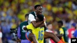 Colombia's Jefferson Lerma (16) and a teammate celebrate their team's 1-0 victory over Uruguay at the end of a Copa America semifinal soccer match in Charlotte, NC, July 10, 2024. 