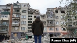 A local resident looks at his home, damaged in today Russian rocket attack in Sloviansk, Donetsk region, Ukraine, Friday, April 14, 2023. 