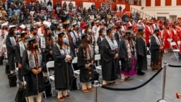 FILE - In this photo provided by Navajo Technical University, students at the school stand during a graduation ceremony, in Crownpoint, New Mexico, Dec. 16, 2022. 