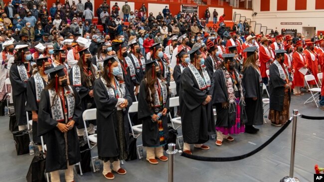 FILE - In this photo provided by Navajo Technical University, students at the school stand during a graduation ceremony, in Crownpoint, New Mexico, Dec. 16, 2022.