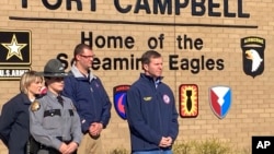 Kentucky Gov. Andy Beshear, center, is seen as military officials hold a news conference in Fort Campbell, Kentucky, March 30, 2023, to discuss a fatal helicopter crash.
