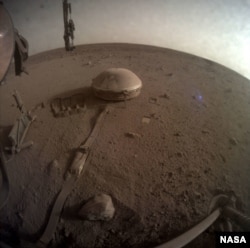 This is one of the last images ever taken by NASA’s InSight Mars lander. Captured on Dec. 11, 2022, it shows InSight’s seismometer on the Red Planet’s surface. (Credits: NASA/JPL-Caltech)