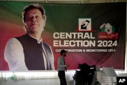 A poster of Pakistani former Prime Minister Imran Khan, who is imprisoned, overlooks his party's office in Islamabad, Pakistan, Feb. 9, 2024.