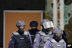 Police officers walk inside an Ismaili Muslim center in Lisbon, Portugal, March 28, 2023.