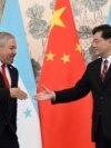 Honduras Foreign Minister Eduardo Enrique Reina Garcia and Chinese Foreign Minister Qin Gang shake hands following the establishment of diplomatic relations between the two countries, in the Diaoyutai State Guesthouse in Beijing, March 26, 2023. 