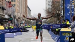 Evans Chebet of Kenya breaks the tape to win the 127th Boston Marathon, in Boston, Massachusetts.