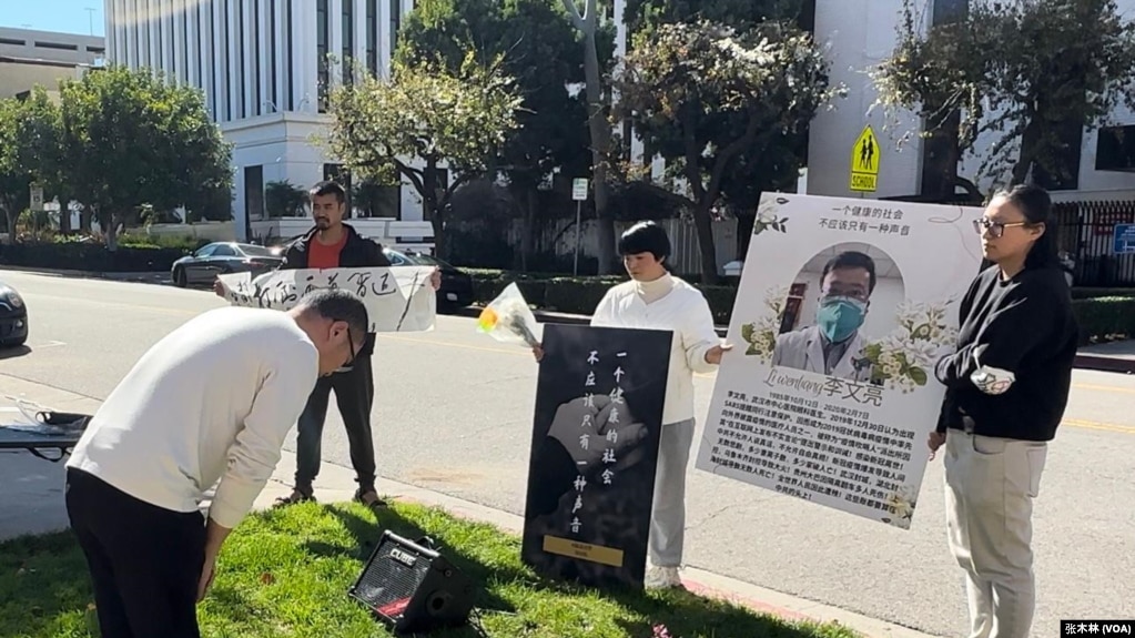 2月10日，活动参与者在洛杉矶中领馆门口向李文亮遗像鞠躬悼念。（2024年2月10日，张木林洛杉矶拍摄）