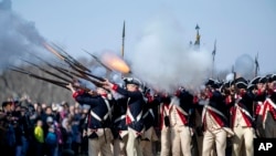 Members of Alpha Company, 3d U.S. Infantry Regiment (The Old Guard), give a firing demonstration on the Bowling Green of George Washington&#39;s Mount Vernon in Mount Vernon, Virginia.