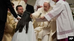 Pope Francis baptizes the faithful during the Easter vigil ceremony in St. Peter's Basilica at the Vatican, April 8, 2023.