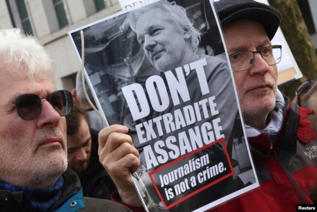 People take part in a protest outside the U.S. embassy in Brussels as the WikiLeaks founder Julian Assange's last-ditch appeal against his extradition to the U.S. is heard in London, in Brussels, Belgium, Feb. 20, 2024.