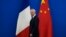 French Finance Minister Bruno Le Maire walks past the French and Chinese flags at the 9th China-France High Level Economic and Financial Dialogue held at the Diaoyutai State Guest House in Beijing, July 29, 2023. 
