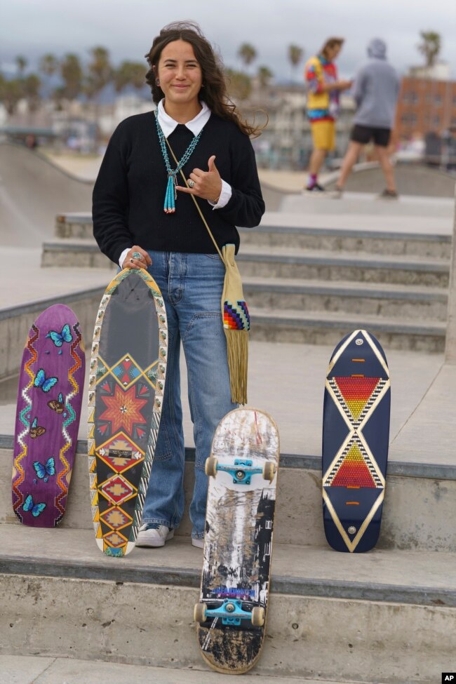 Di'Orr Greenwood, whose work is featured on the new US stamps, poses for a picture with her painted skateboards in the Venice Beach neighborhood in Los Angeles, March 20, 2023.