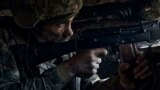 A Ukrainian soldier of the 28th Brigade fires during a battle with Russian troops at the front line near Bakhmut, Donetsk region, Ukraine, March 24, 2023.