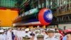 Navy personnel are pictured with Taiwan's first domestically made submarine during the launching ceremony at CSBC Corp.'s shipyards in Kaohsiung, Taiwan, Sept. 28, 2023.