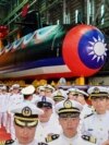 Navy personnel are pictured with Taiwan's first domestically made submarine during the launching ceremony at CSBC Corp.'s shipyards in Kaohsiung, Taiwan, Sept. 28, 2023.
