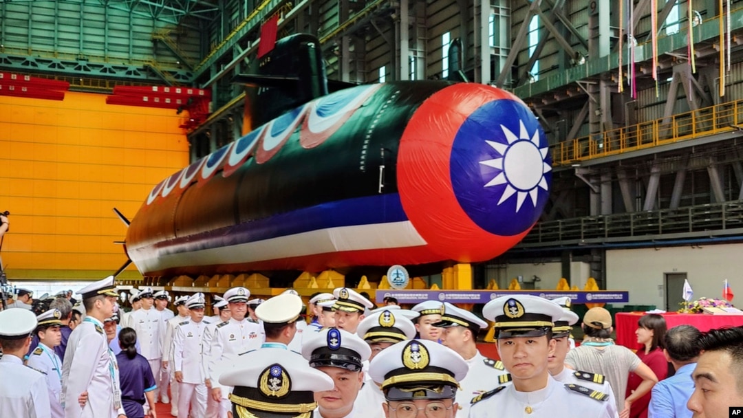 Navy personnel are pictured with Taiwan's first domestically made submarine during the launching ceremony at CSBC Corp.'s shipyards in Kaohsiung, Taiwan, Sept. 28, 2023.