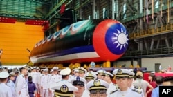 Navy personnel are pictured with Taiwan's first domestically made submarine during the launching ceremony at CSBC Corp.'s shipyards in Kaohsiung, Taiwan, Sept. 28, 2023.